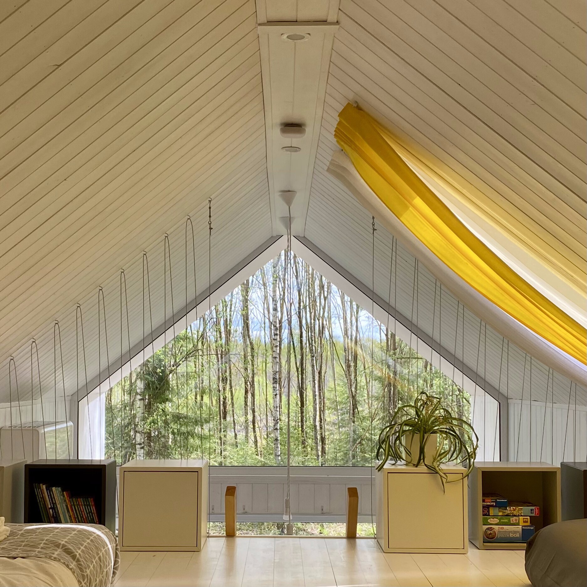 Loft A-frame window looking into the birch forest